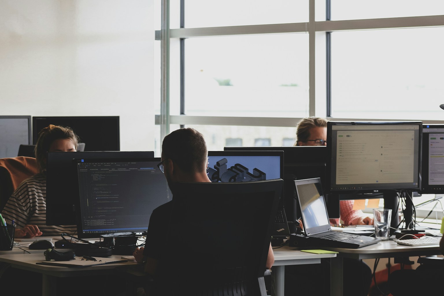 A diverse team of developers collaborating on a complex project, symbolizing the power of multi-agent AI working together under an orchestrator.