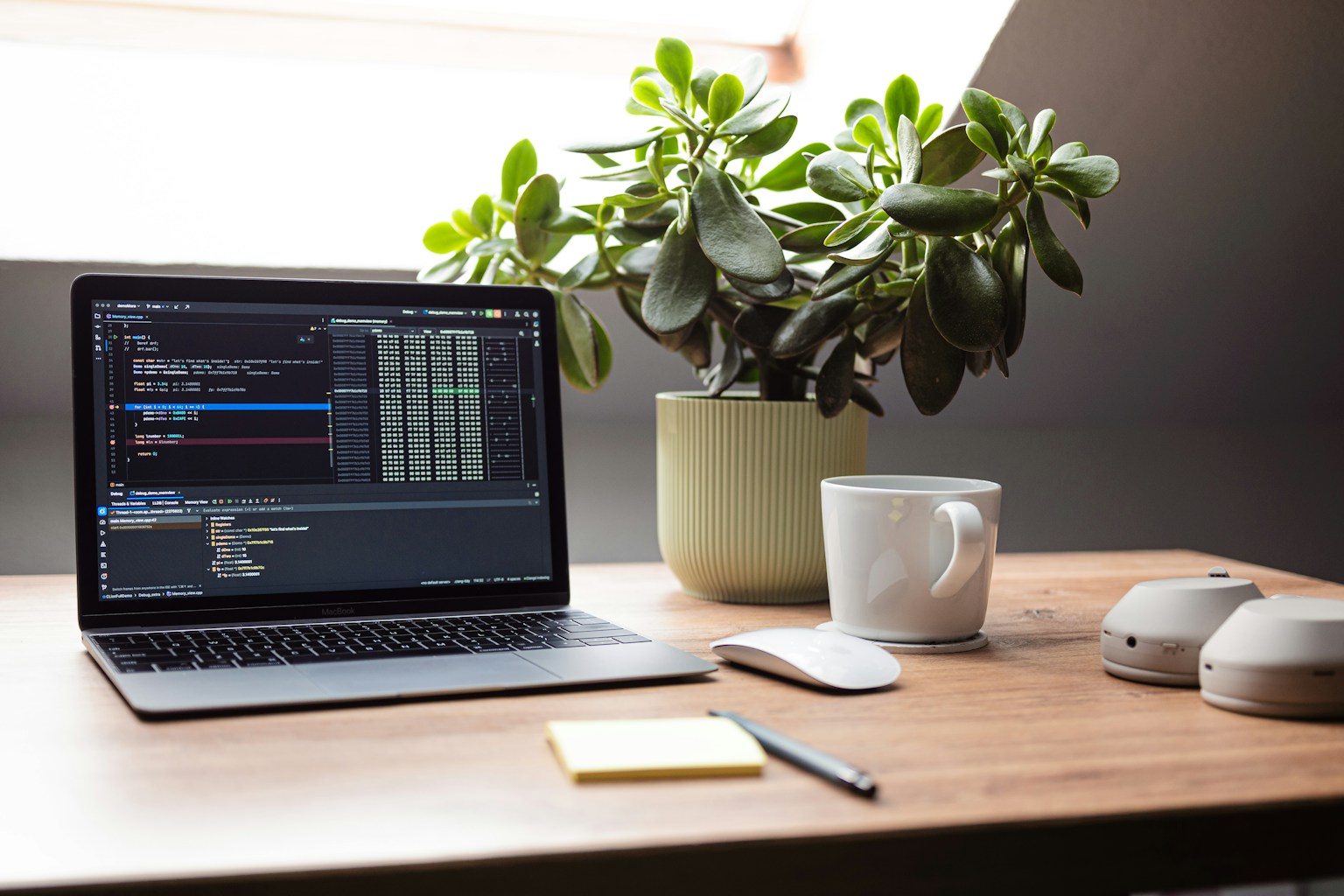 A developer's desk with a laptop displaying code, a coffee cup, and a notebook, suggesting deep work and problem-solving assisted by AI.